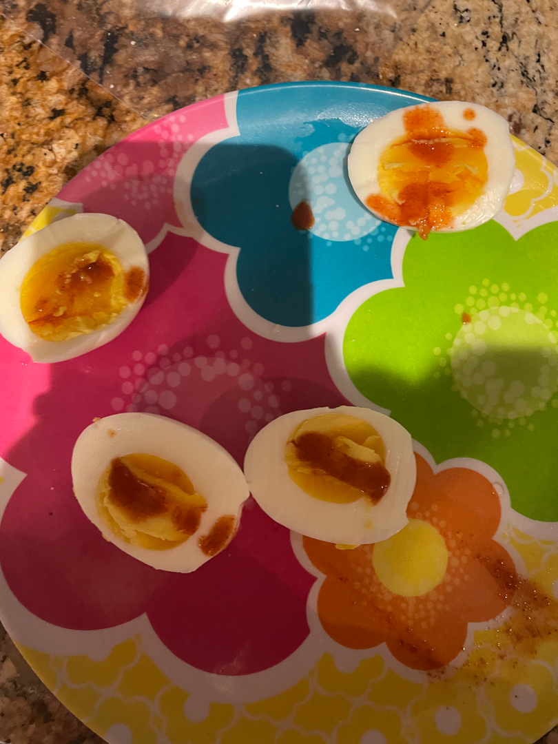 hard boiled eggs with hot sauce