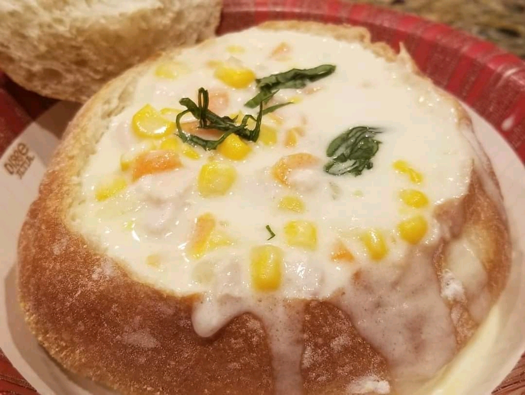 Creamy chicken soup in bread bowl